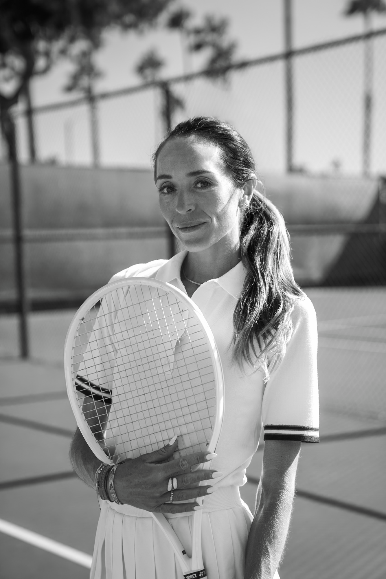 Molly Worden holding a tennis racket on court