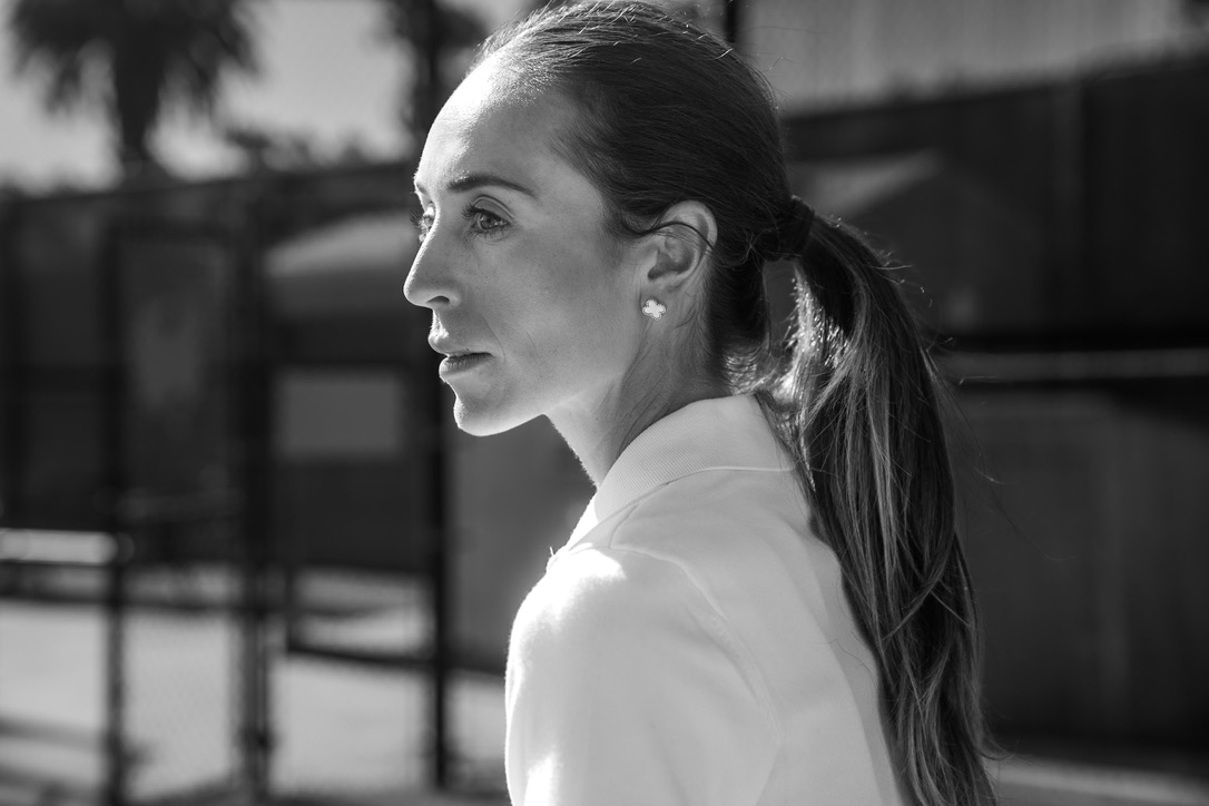 Molly Worden in profile on a tennis court